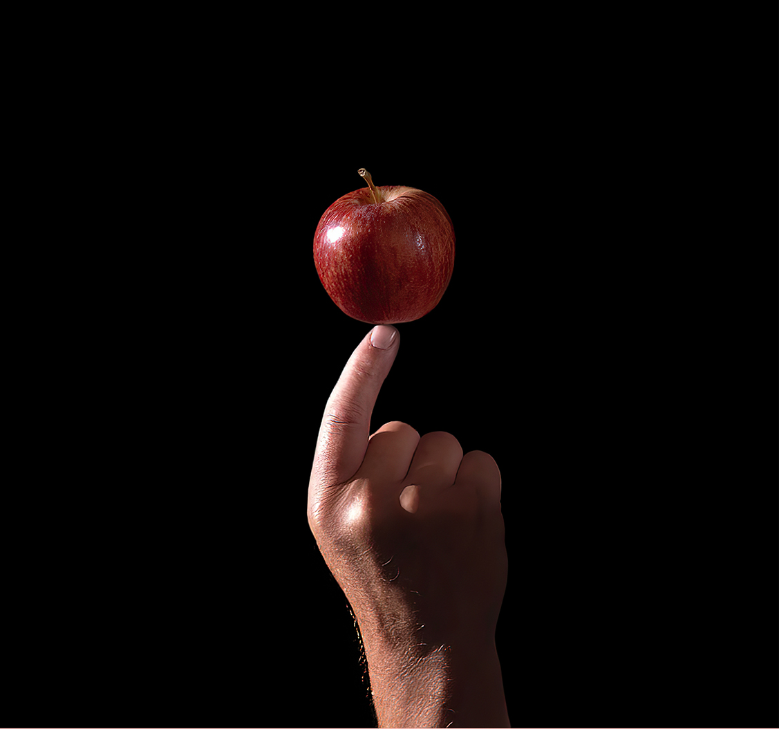 Äpple på ett finger